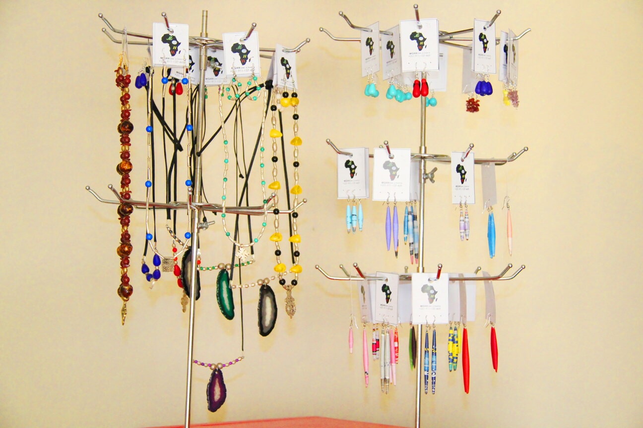 Earrings arranged on a white jewellery stand