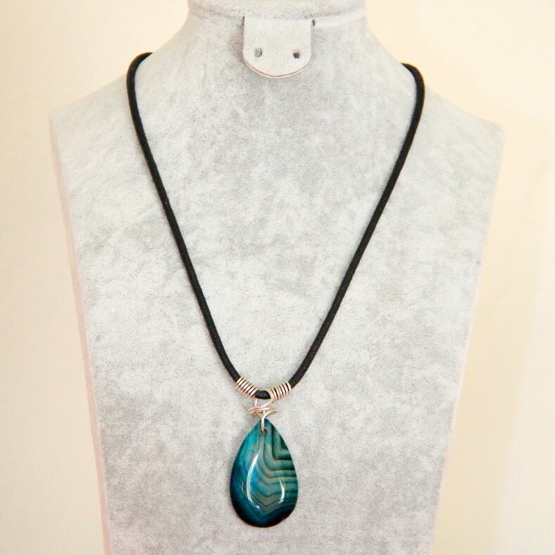 Green teardrop pendant on a black cord