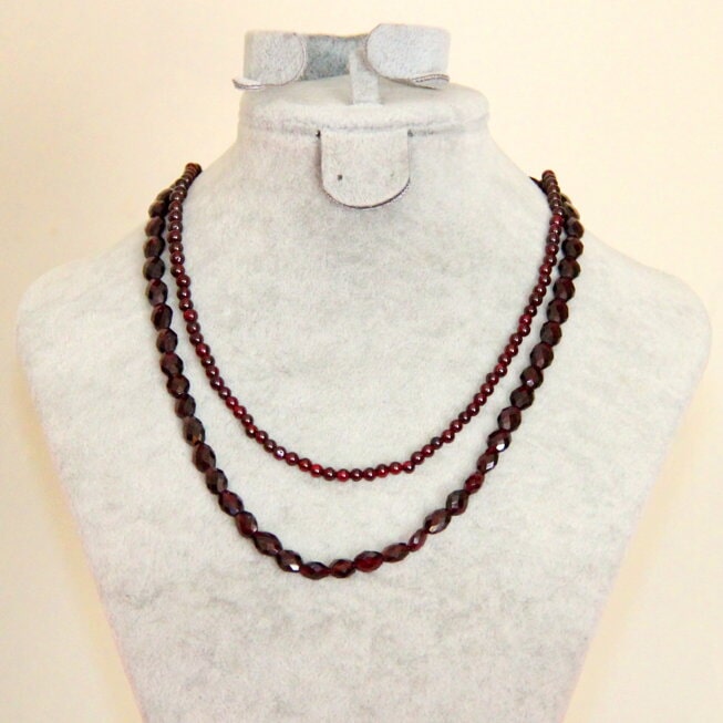 Three strands of dark red beads